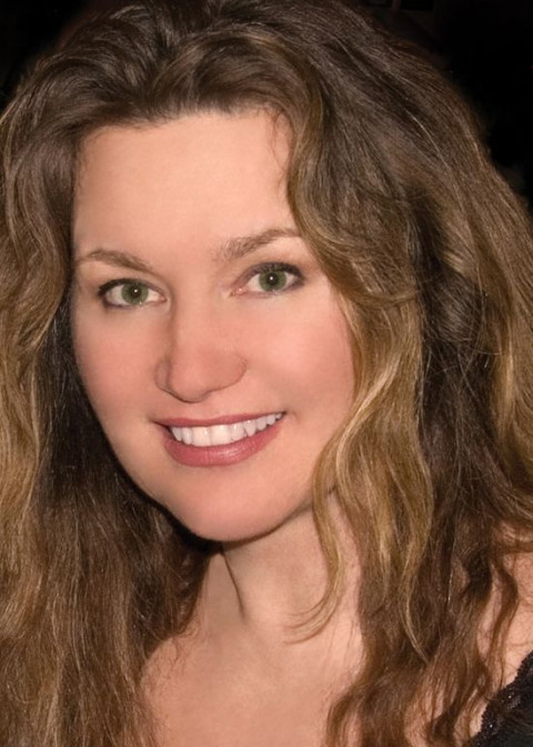 headshot of smiling woman with long brown hair